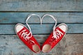 A pair of red retro sneakers on a blue wooden background, laces Royalty Free Stock Photo