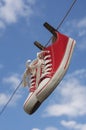 Pair of red sneakers hanging on clothesline Royalty Free Stock Photo