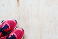 Pair of red sport shoes laid on grunge wooden floor background, Royalty Free Stock Photo