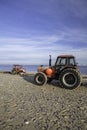 Pair of red tractors on the beach Royalty Free Stock Photo