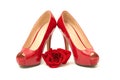 A pair red of  women`s heel shoes with red rose isolated on white background Royalty Free Stock Photo