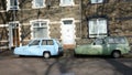 A Pair of Reliant Robins, a Three-Wheeled Car Made in England