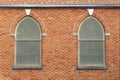 Retro arched vintage church windows red brick wall Royalty Free Stock Photo
