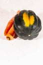 Pair of ripe, freshly picked, organic carrots and one acorn squash, on white background