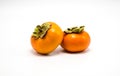 Two orange persimmons isolated on white