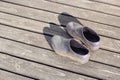 Pair rubber galoshes stand on wooden boards