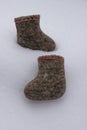 A pair of Russian felt boots standing on white snow in winter Royalty Free Stock Photo