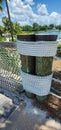 Pair of rustic wooden dock posts wrapped with thick twisted coils of mariner rope