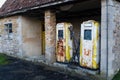 A pair of rusting old yellow petrol pump