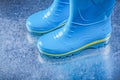 Pair of safety gumboots on metallic background