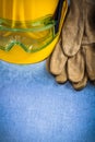 Pair of safety leather gloves hard hat and protective goggles on Royalty Free Stock Photo