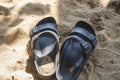 A pair of sandals on the white sand of the beach Royalty Free Stock Photo