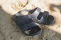 A pair of sandals on the white sand of the beach Royalty Free Stock Photo