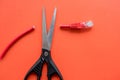 With a pair of scissors cut the connector at the red cable red background Royalty Free Stock Photo
