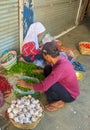 A pair of sellers arranges their wares on the terrace of a closed shop at Pasar Tanjung, a traditional market, Jember, East Java