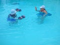 Pair of seniors exercise in a pool