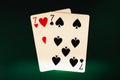 A pair of sevens on a black background, poker background. Seven of hearts and seven of spades.
