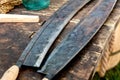 Pair of sharp hand tools for removing bark from a tree trunk, the traditional method