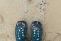 A pair of shoes, seen from above, standing in the sand Royalty Free Stock Photo