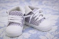 A pair of shoes for a young baby. Purple shoes for baby on the blanket Royalty Free Stock Photo