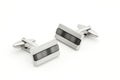 Pair of silver cuff links over white Royalty Free Stock Photo