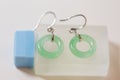 Pair of silver earring with circle jade closeup