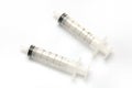 A pair of six millilitre syringes