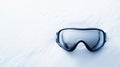 A pair of ski goggles displayed on a clean, snow-white background with Royalty Free Stock Photo