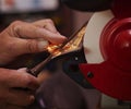 Sharpening a chisel on a grinding wheel. Royalty Free Stock Photo