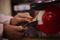 Sharpening a chisel on a grinding wheel. Royalty Free Stock Photo