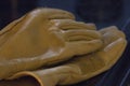 pair of slightly worn yellow leather work gloves