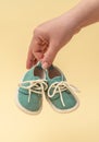 Female hand holding tiny baby shoes. Newborn concept. Royalty Free Stock Photo