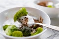 A pair of small dessert bowls with fresh kiwi fruit, white ice cream, yogurt and chocolate chips on a white stone background Royalty Free Stock Photo