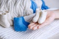 A pair of small felt boots made of handmade wool in children's palms. Traditional home handicrafts made from natural Royalty Free Stock Photo