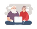 Pair of smiling elderly man and woman surfing internet together. Happy old couple watching video on laptop. Grandparents Royalty Free Stock Photo
