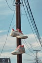 a pair of sneakers hanging on a power line