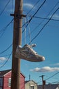 a pair of sneakers hanging on a power line