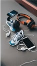 A pair of sneakers, headphones, and a smartphone on the pavement illustration Artificial Intelligence artwork generated Royalty Free Stock Photo