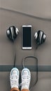 A pair of sneakers, headphones, and a smartphone on the pavement illustration Artificial Intelligence artwork generated Royalty Free Stock Photo