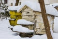 A pair of snow covered bee hives. Apiary in wintertime. Beehives covered with snow in wintertime.