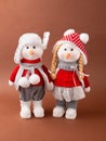 A pair of snowmen girl and boy Christmas toy in a warm hat and pants. New Year and Christmas