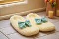 a pair of spa-style slippers on a white chenille bath mat Royalty Free Stock Photo