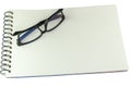 Pair of spectacles lying closed on a sketch book