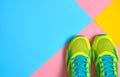 Pair of sport shoes on colorful background. New sneakers on pink, blue and yellow pastel background, copy space. Royalty Free Stock Photo