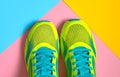 Pair of sport shoes on colorful background. New sneakers on pink, blue and yellow pastel background, copy space. Royalty Free Stock Photo