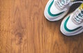 Pair of sport shoes on wooden background. New sneakers and space for ad text