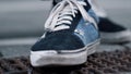 Pair of sporty sneakers on asphalt. Closeup blue shoes for fitness outdoor. Royalty Free Stock Photo