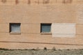 Square vintage windows facade brown brick wall warehouse building Royalty Free Stock Photo