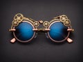 Pair of Steampunk Sunglasses Designed with Intricate Clockwork Gears and Blue Lenses Royalty Free Stock Photo