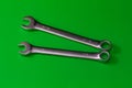 Pair of Steel Wrenches on Solid Green